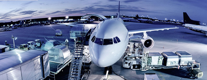 Cargo plane being loaded at night, elevated view